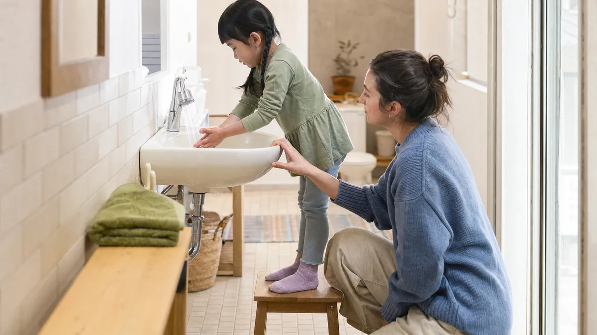 A child practising one small step with a therapist.